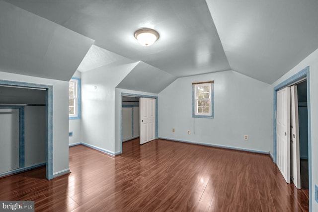 additional living space with lofted ceiling and dark wood-type flooring