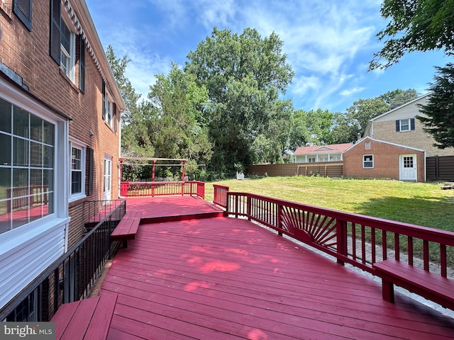 wooden terrace featuring a lawn