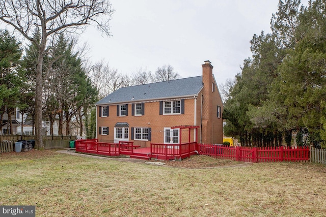 back of property featuring a yard and a deck