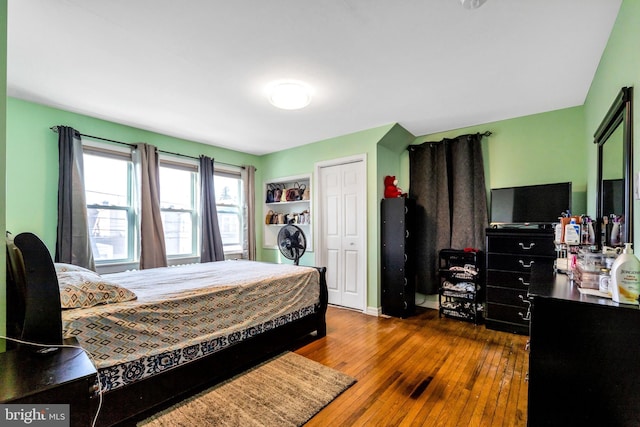 bedroom with dark hardwood / wood-style floors