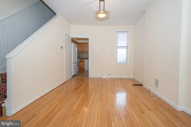 unfurnished living room with light wood-type flooring