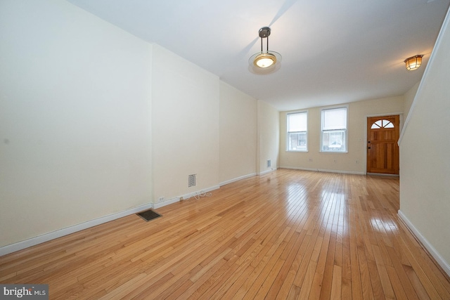 spare room with light hardwood / wood-style flooring