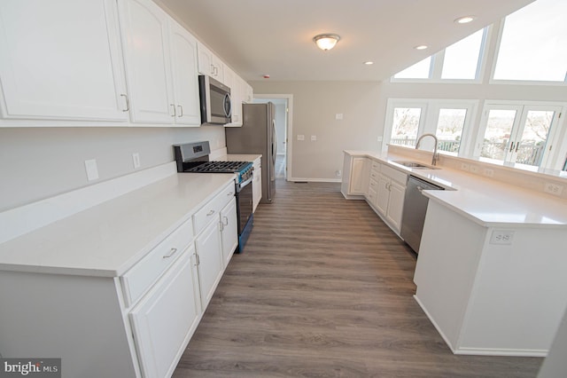 kitchen featuring stainless steel appliances, sink, and white cabinets