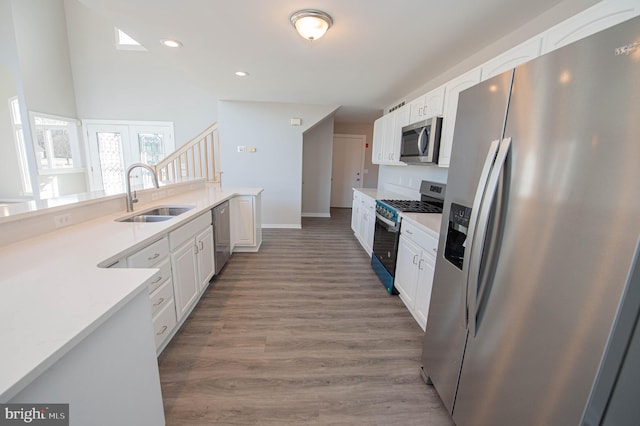 kitchen featuring dark wood-type flooring, stainless steel appliances, sink, and white cabinets