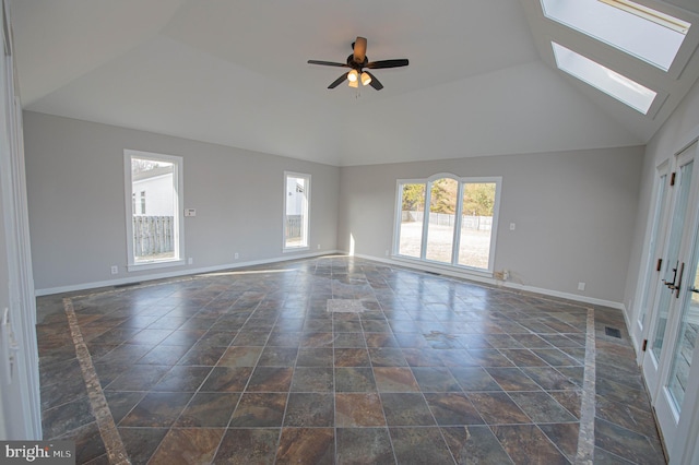 interior space featuring lofted ceiling with skylight and ceiling fan