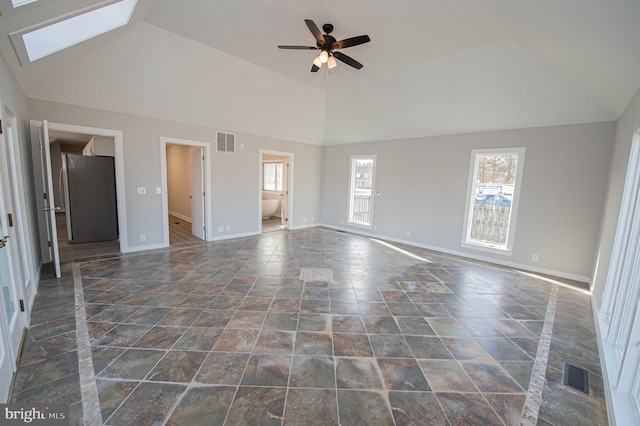 interior space featuring high vaulted ceiling, ceiling fan, and a skylight