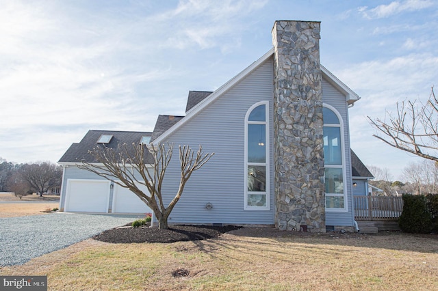 view of home's exterior featuring a garage and a lawn