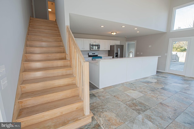 staircase with a towering ceiling