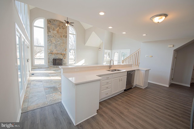 kitchen with sink, white cabinets, kitchen peninsula, and dishwasher