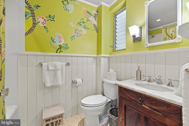 bathroom featuring vanity, ornamental molding, and toilet