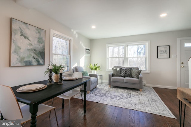 living room featuring a wealth of natural light and dark hardwood / wood-style flooring