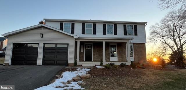 view of front of property featuring a garage and covered porch