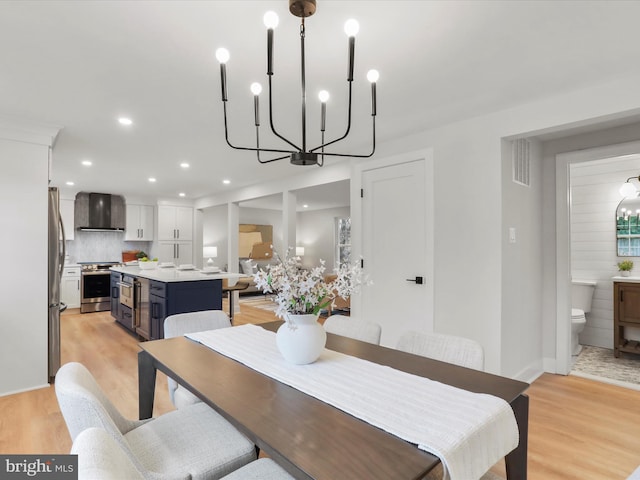 dining room with a chandelier and light hardwood / wood-style flooring