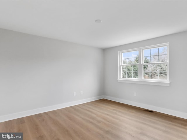 spare room with light hardwood / wood-style floors