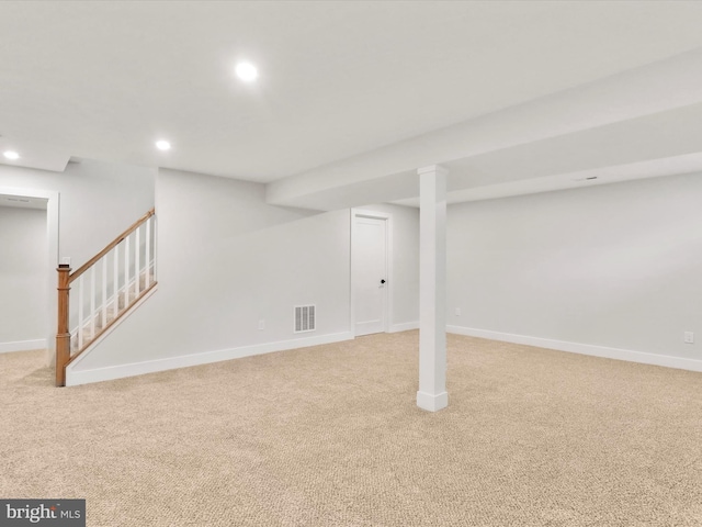 basement featuring light carpet