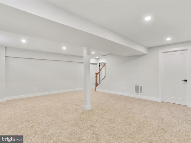 basement featuring light colored carpet