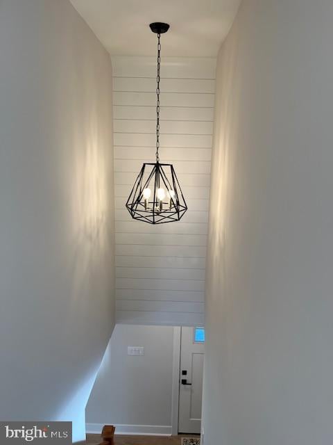 stairway with an inviting chandelier