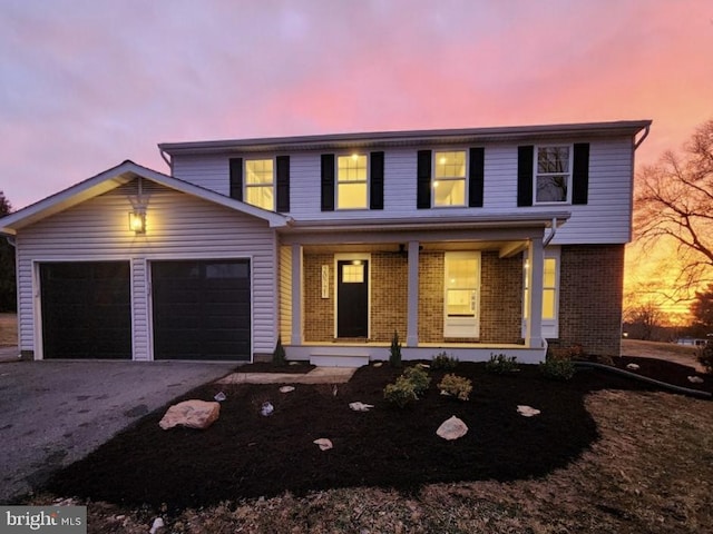 front facade with a garage and covered porch