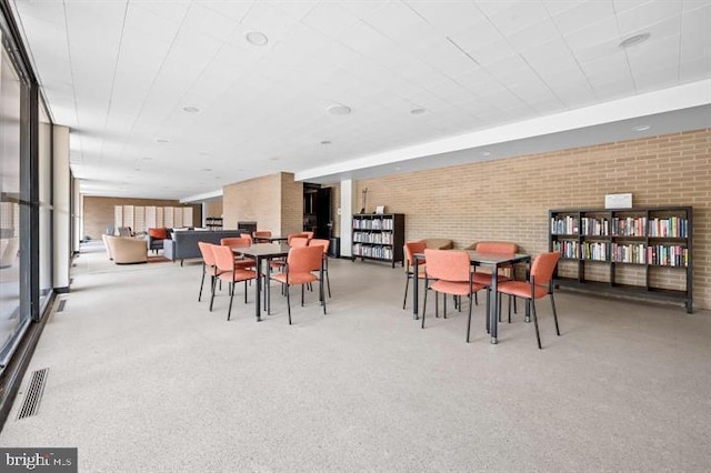 dining space with brick wall