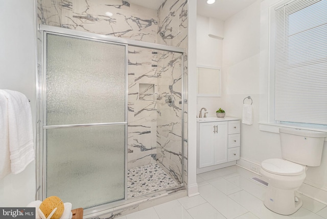 bathroom featuring sink, a shower with door, and toilet