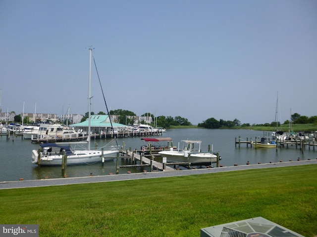 view of dock featuring a water view and a lawn