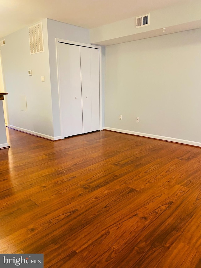 unfurnished bedroom featuring wood-type flooring and a closet