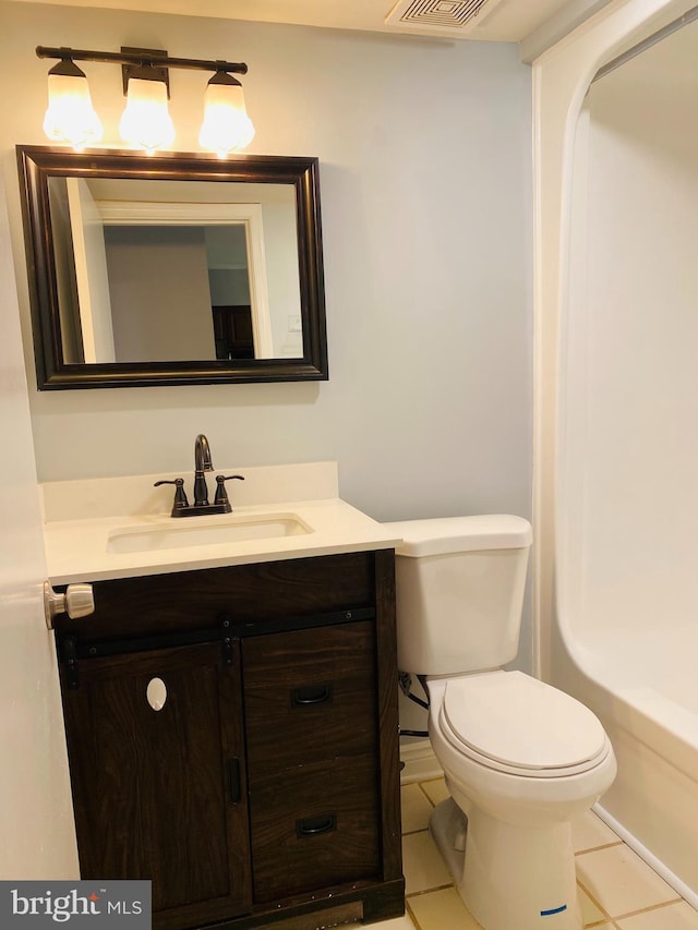 bathroom with vanity, a tub, tile patterned floors, and toilet