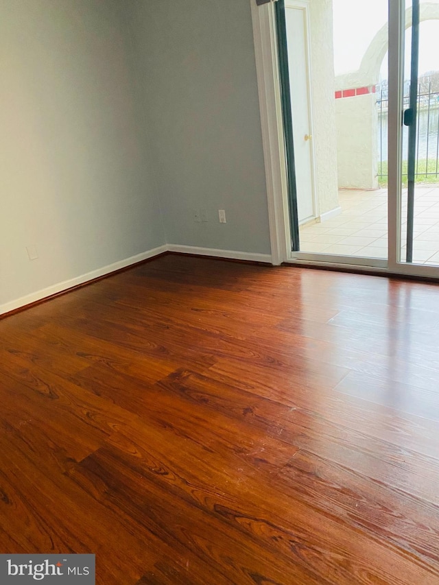 spare room with hardwood / wood-style flooring