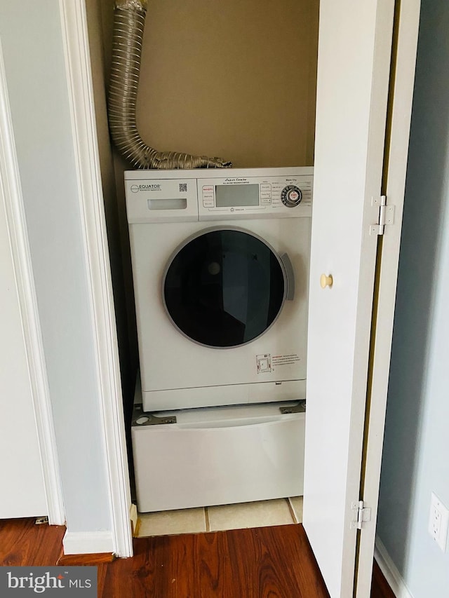 washroom with stacked washer / dryer