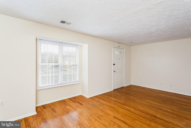 interior space with hardwood / wood-style flooring and a textured ceiling