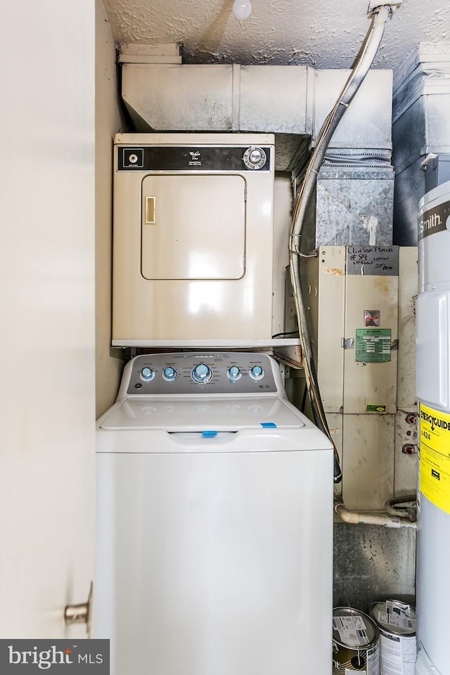 laundry room featuring stacked washer / drying machine