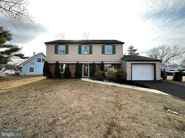 front facade with a garage and a front yard