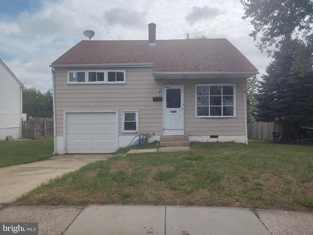 view of front of house with a garage and a front yard