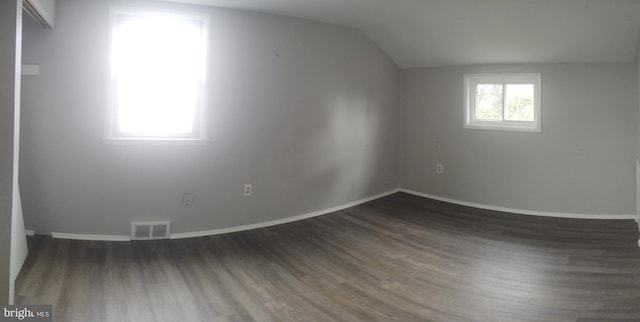 bonus room featuring dark wood-type flooring and lofted ceiling