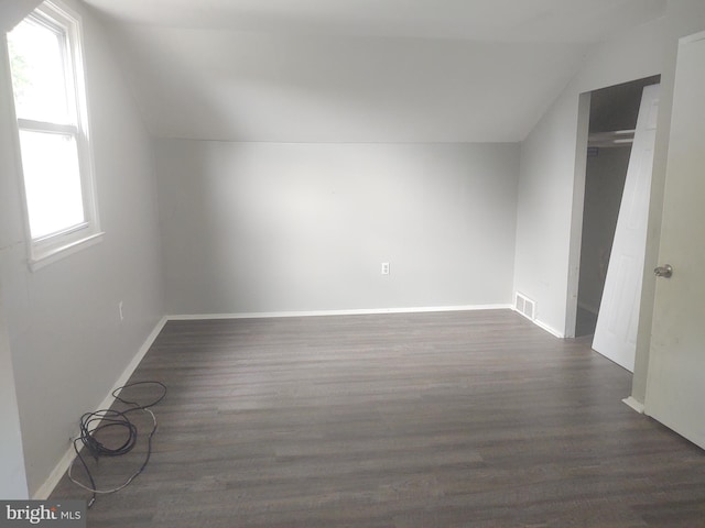 additional living space with lofted ceiling and dark hardwood / wood-style floors