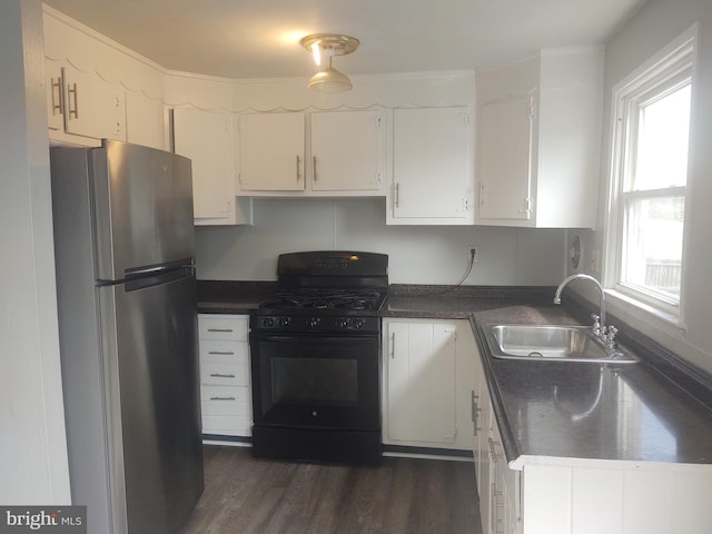 kitchen with white cabinetry, sink, black range with gas stovetop, and stainless steel refrigerator