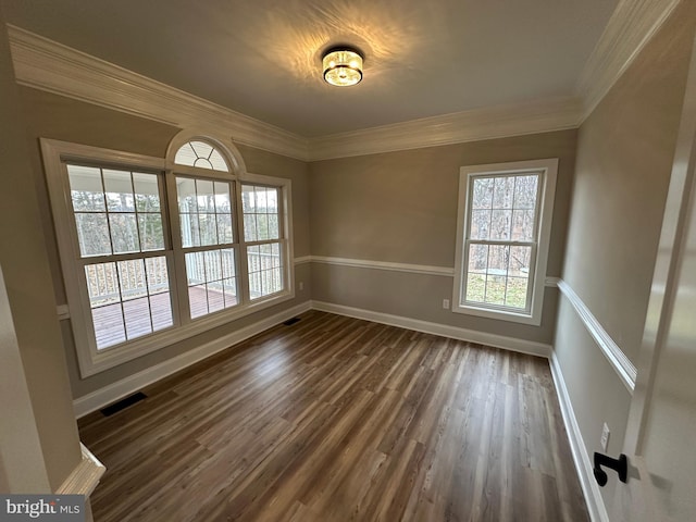 unfurnished room with dark wood-type flooring and ornamental molding