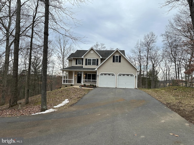 front facade featuring a garage and covered porch