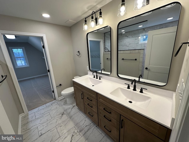 bathroom featuring vanity, tiled shower, and toilet