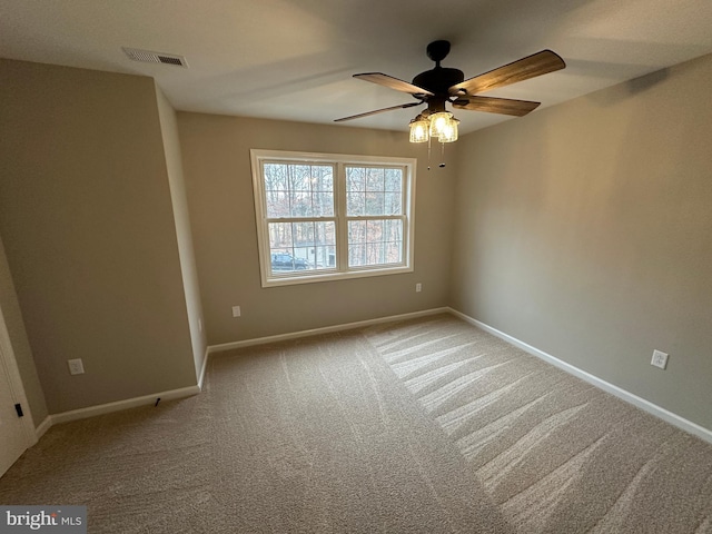 carpeted spare room with ceiling fan