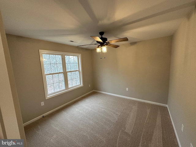 empty room featuring carpet floors and ceiling fan