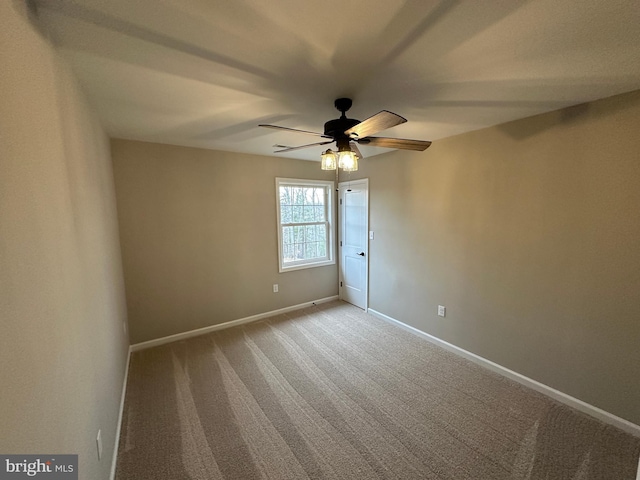 carpeted spare room with ceiling fan