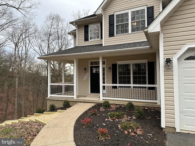 property entrance featuring a porch and a garage