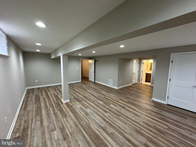 basement featuring hardwood / wood-style floors