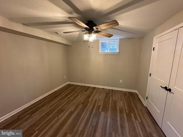 empty room with ceiling fan and dark hardwood / wood-style floors