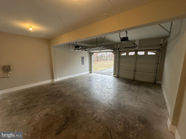 garage with a garage door opener and electric panel