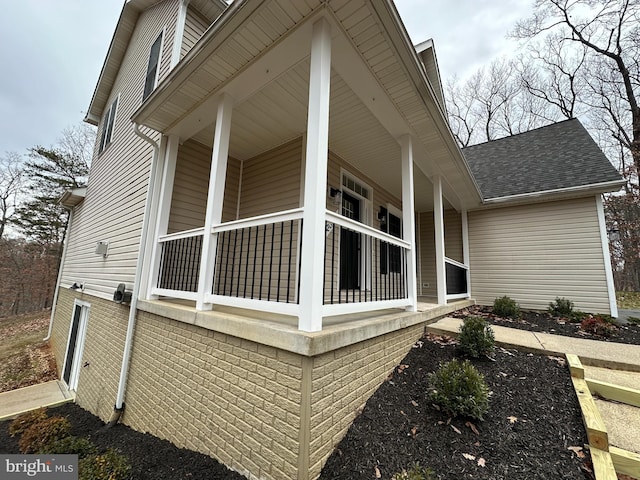 view of side of property with a porch