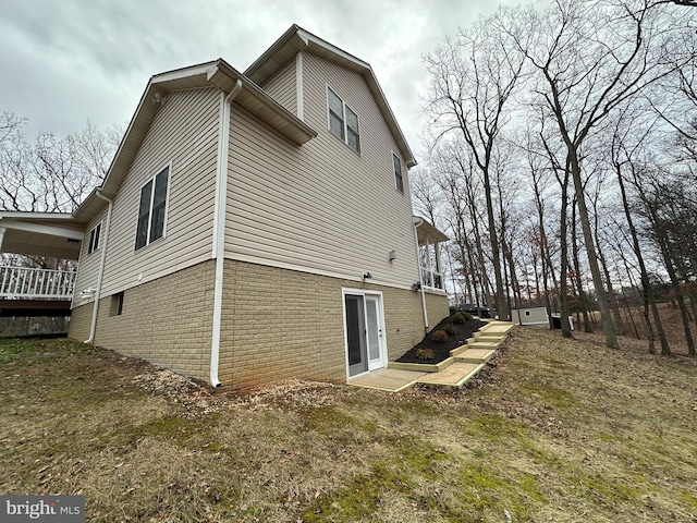 rear view of property featuring a yard