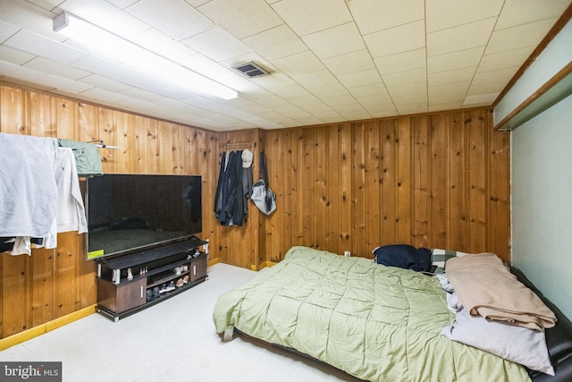 bedroom with wood walls