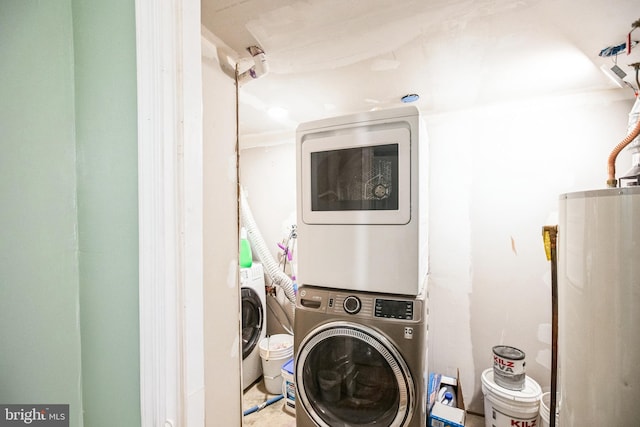 clothes washing area featuring stacked washer and dryer